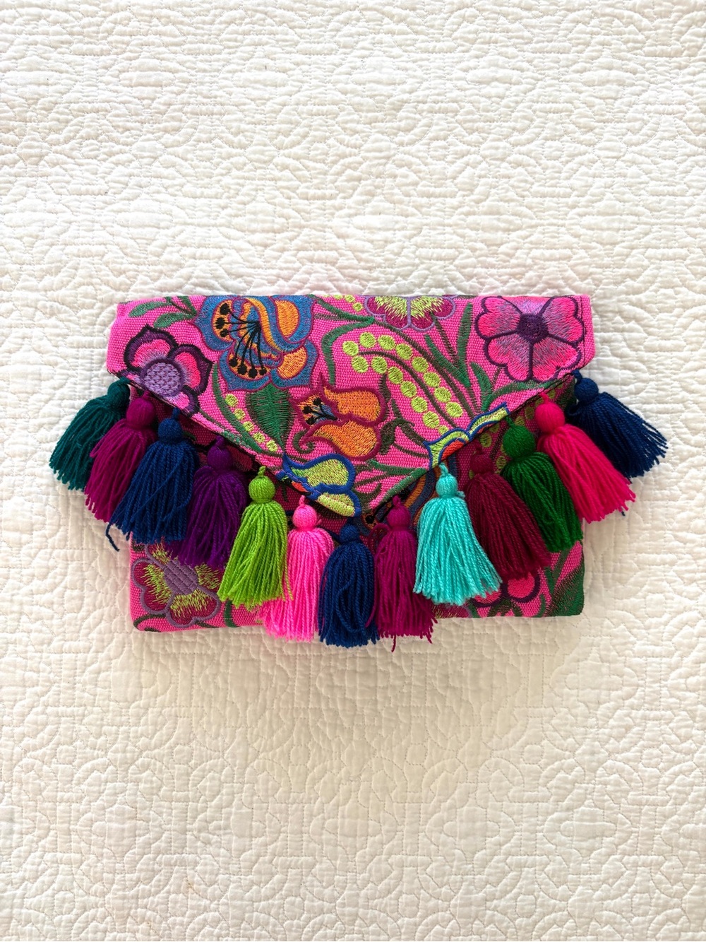 Embroidered clutch with tassel detail